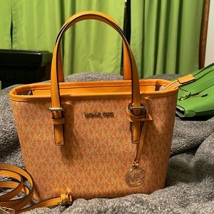 A small but very pretty color Michael Kors purse.